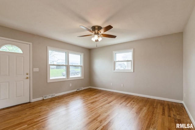 entrance foyer with a wealth of natural light, light wood finished floors, and visible vents