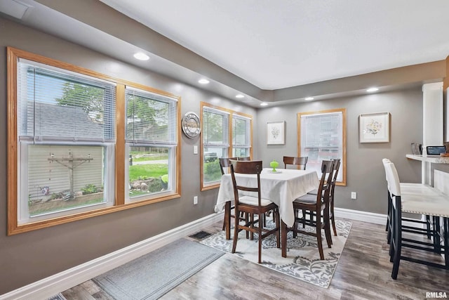 dining space with baseboards, recessed lighting, and wood finished floors