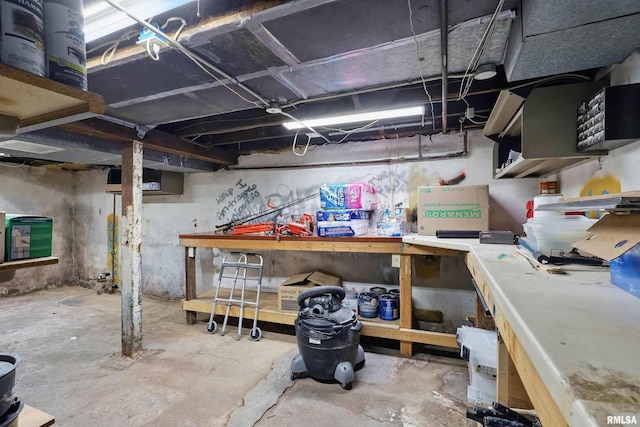 unfinished basement with a workshop area