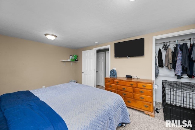 bedroom featuring light colored carpet and a closet