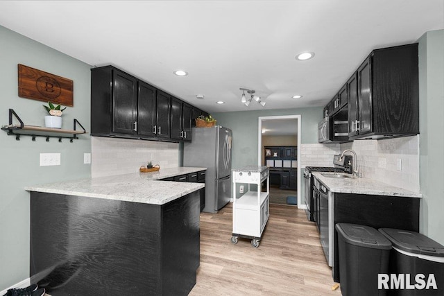 kitchen with tasteful backsplash, dark cabinetry, open shelves, and recessed lighting