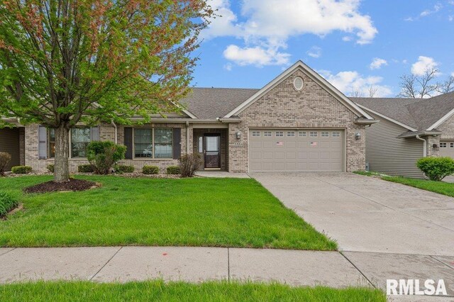 ranch-style home with concrete driveway, a front yard, brick siding, and an attached garage