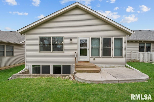 back of property featuring a patio area, fence, a lawn, and entry steps