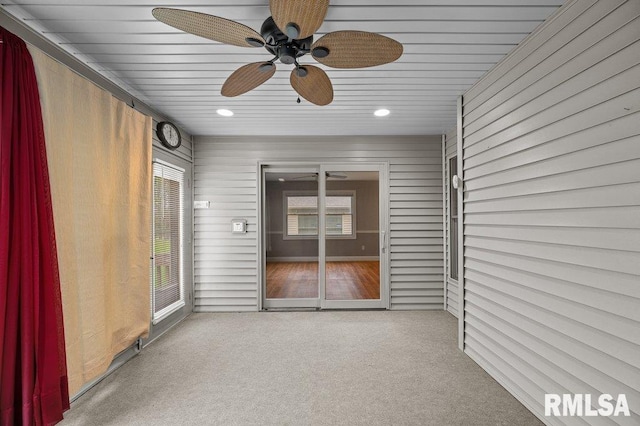 unfurnished sunroom with a ceiling fan