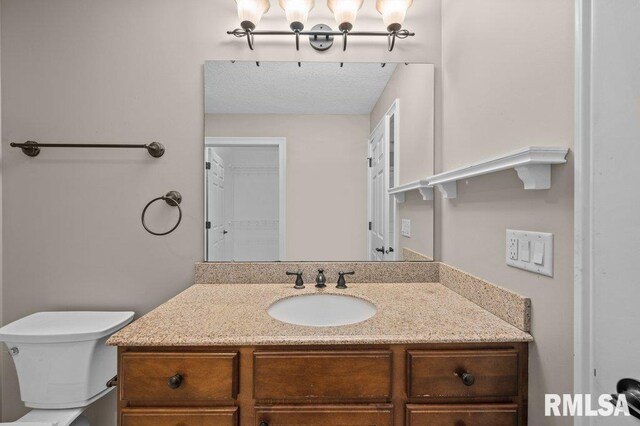bathroom featuring toilet and vanity