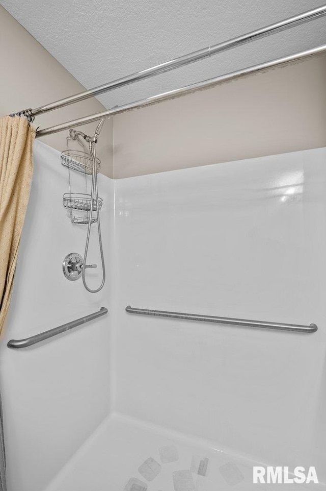 bathroom featuring a shower stall