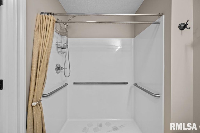 full bath with a stall shower and a textured ceiling
