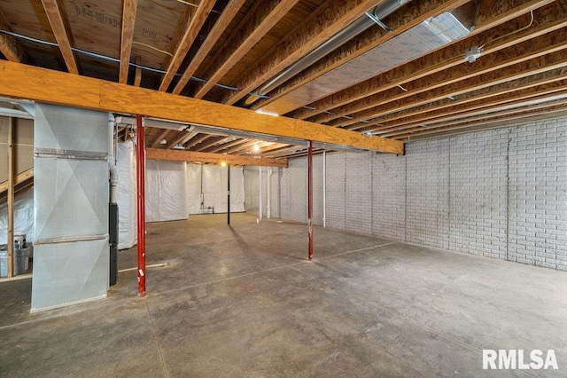 unfinished basement featuring heating unit