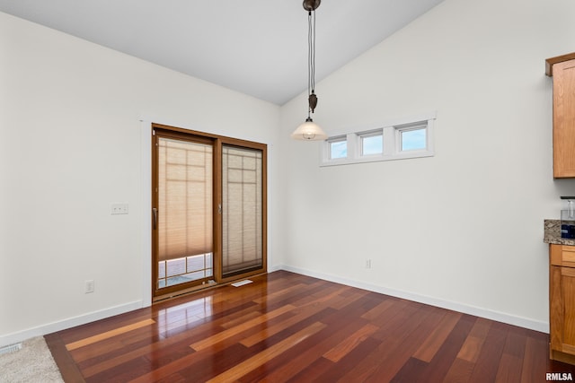 17 Blackstone Way, Le Claire, IA 52753 - unfurnished dining area featuring dark wood-style flooring, baseboards, and high vaulted ceiling
