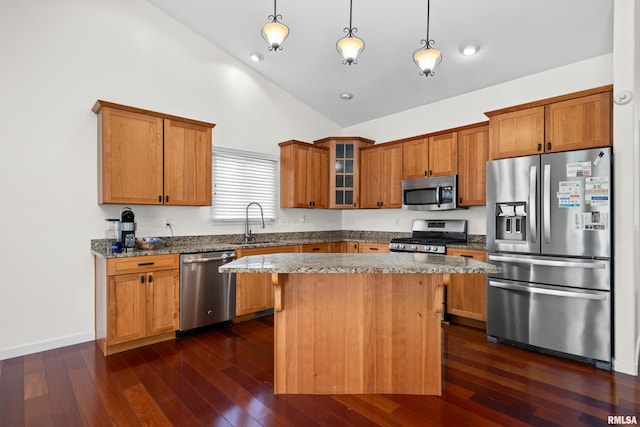 17 Blackstone Way, Le Claire, IA 52753 - kitchen featuring appliances with stainless steel finishes, a sink, high vaulted ceiling, stone countertops, and a center island