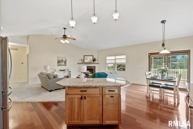 17 Blackstone Way, Le Claire, IA 52753 - kitchen featuring freestanding refrigerator, lofted ceiling, a ceiling fan, hardwood / wood-style flooring, and open floor plan