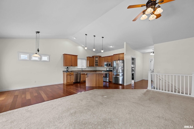 17 Blackstone Way, Le Claire, IA 52753 - kitchen featuring stainless steel appliances, open floor plan, brown cabinets, a kitchen island, and dark carpet