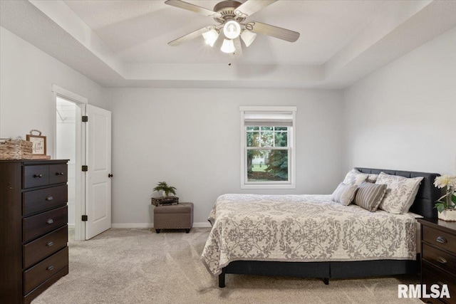 17 Blackstone Way, Le Claire, IA 52753 - bedroom featuring a raised ceiling, light carpet, a ceiling fan, and baseboards