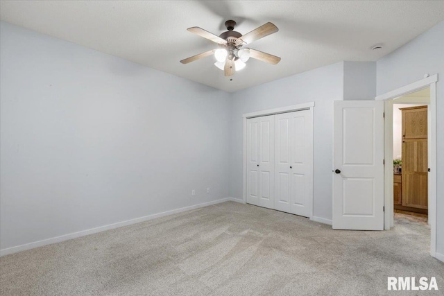 17 Blackstone Way, Le Claire, IA 52753 - unfurnished bedroom featuring light carpet, baseboards, a closet, and ceiling fan