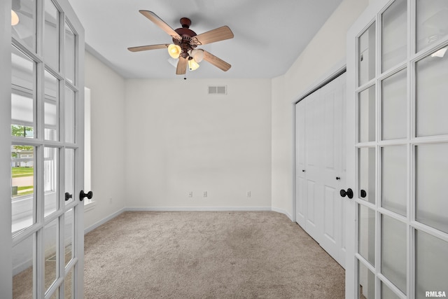 17 Blackstone Way, Le Claire, IA 52753 - unfurnished bedroom featuring carpet flooring, french doors, baseboards, a closet, and ceiling fan