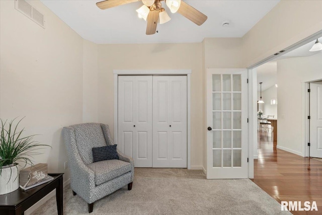 17 Blackstone Way, Le Claire, IA 52753 - living area with ceiling fan, french doors, baseboards, and carpet floors