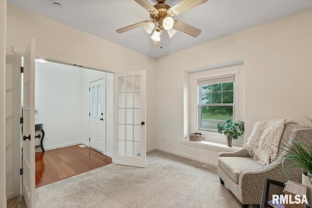 17 Blackstone Way, Le Claire, IA 52753 - sitting room with french doors, carpet, baseboards, and ceiling fan