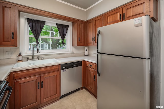 kitchen with stainless steel appliances, brown cabinetry, ornamental molding, and a sink