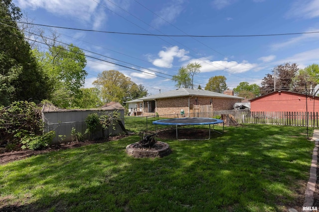 view of yard featuring a fenced backyard and a trampoline