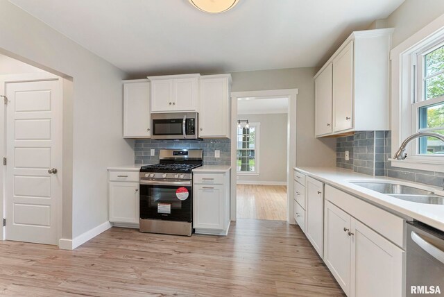 spare room with baseboards, a ceiling fan, and wood finished floors