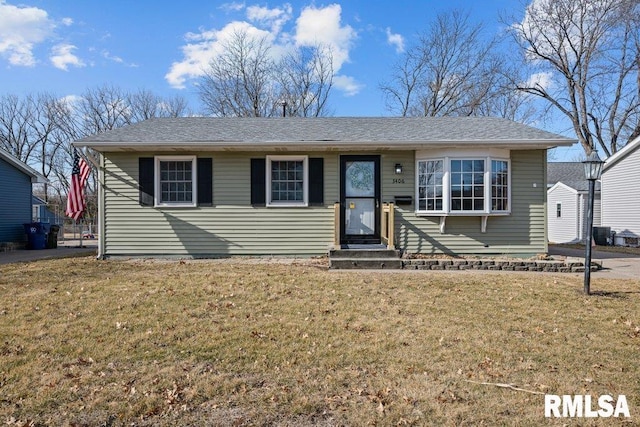 view of front of home featuring a front lawn and central AC unit