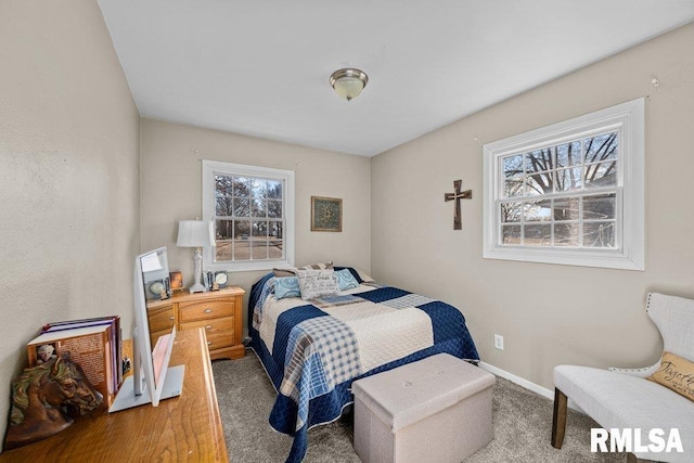 carpeted bedroom featuring baseboards