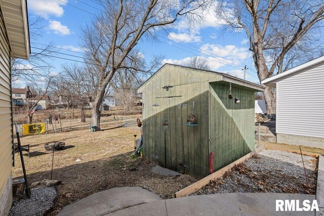 view of shed featuring fence