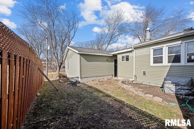 back of house featuring fence