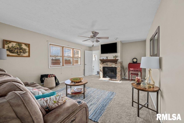 living room with a textured ceiling, carpet, a brick fireplace, a ceiling fan, and baseboards