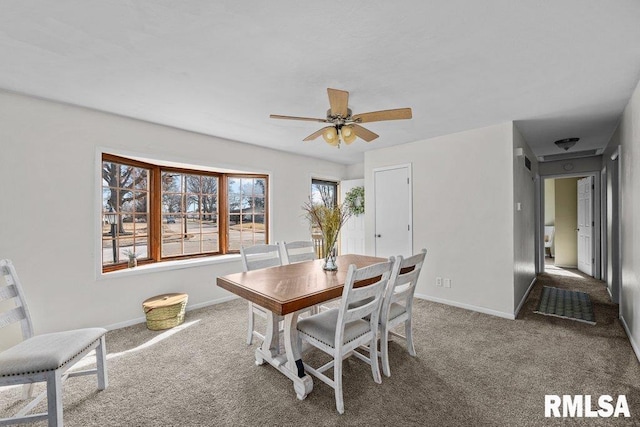 dining area with baseboards, ceiling fan, and carpet floors