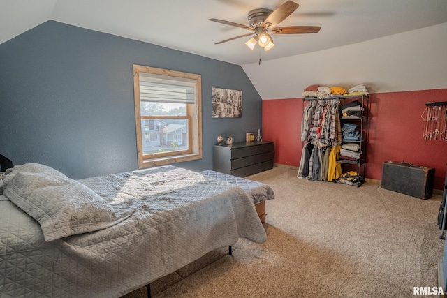 carpeted bedroom featuring a ceiling fan and vaulted ceiling