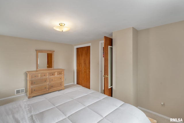 bedroom with light colored carpet, baseboards, and a closet