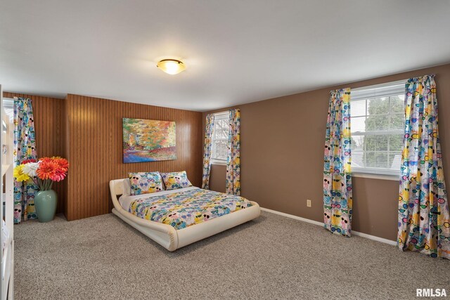 bedroom featuring multiple windows, carpet, and baseboards