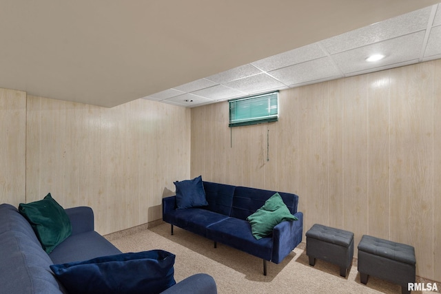 living room with carpet floors, wooden walls, a paneled ceiling, and recessed lighting