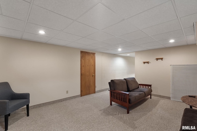 sitting room with carpet flooring, recessed lighting, a drop ceiling, and baseboards