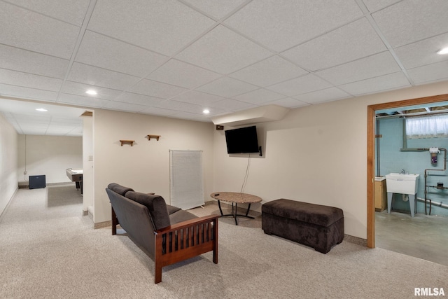 living area with recessed lighting, a drop ceiling, baseboards, and carpet