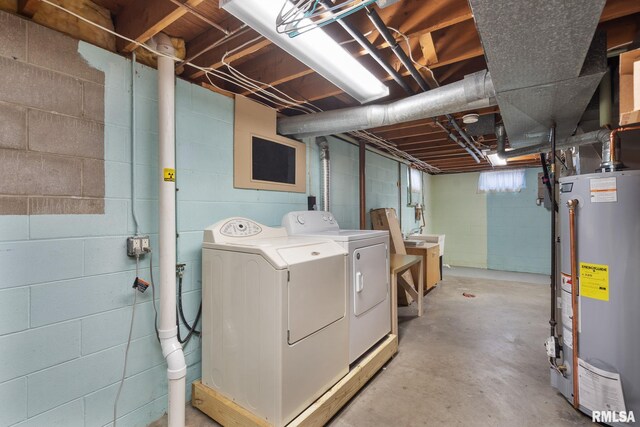 unfinished basement with gas water heater and washing machine and clothes dryer