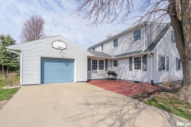 traditional home with concrete driveway, a garage, and roof with shingles