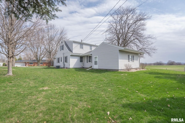 back of house featuring a lawn and central AC unit