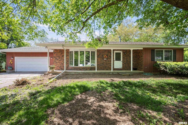 ranch-style home featuring an attached garage, concrete driveway, and brick siding