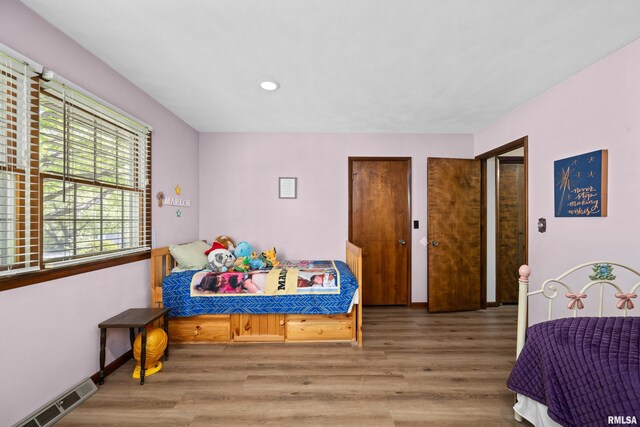 bedroom with wood finished floors and recessed lighting