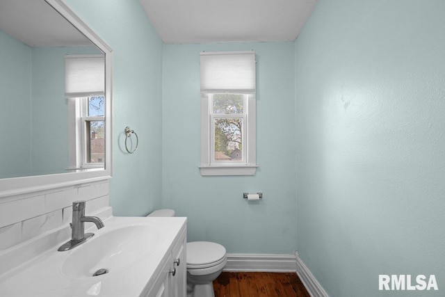 2350 Jefferson Ave, Davenport, IA 52803 - bathroom with baseboards, healthy amount of natural light, toilet, and wood finished floors