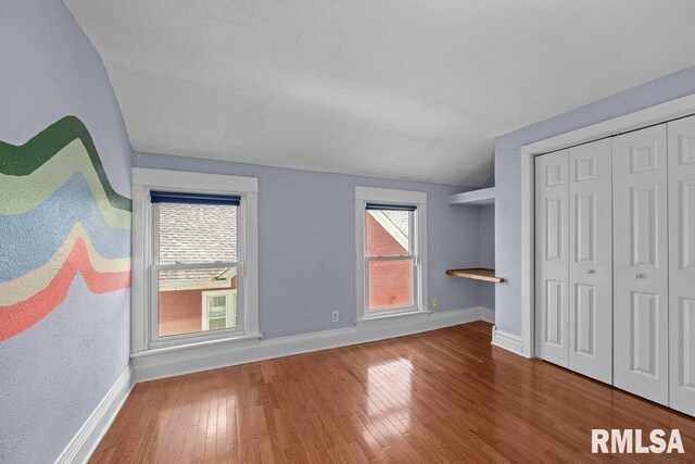 2350 Jefferson Ave, Davenport, IA 52803 - unfurnished bedroom with baseboards, hardwood / wood-style flooring, and a closet