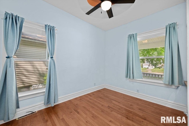 2350 Jefferson Ave, Davenport, IA 52803 - spare room with baseboards, wood finished floors, a ceiling fan, and vaulted ceiling