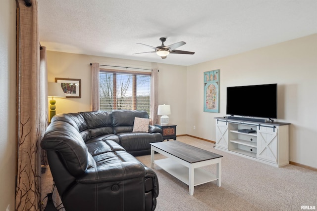 living room with ceiling fan, baseboards, and carpet flooring
