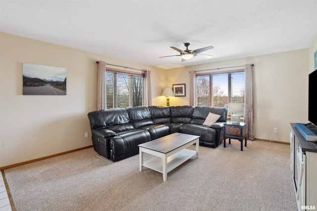 living room featuring a ceiling fan, plenty of natural light, and light colored carpet