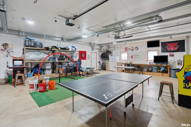 rec room with concrete floors and a garage