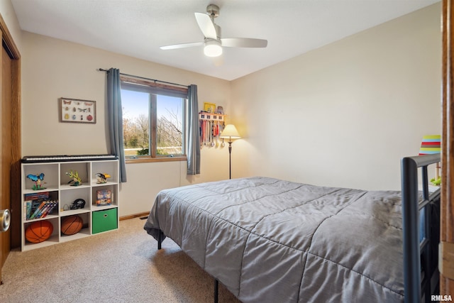 bedroom with carpet, a ceiling fan, and baseboards