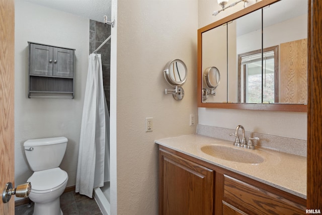bathroom with a shower with curtain, toilet, vanity, tile patterned floors, and baseboards