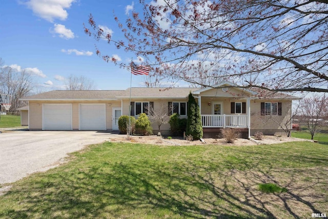 ranch-style home with covered porch, a garage, driveway, and a front lawn